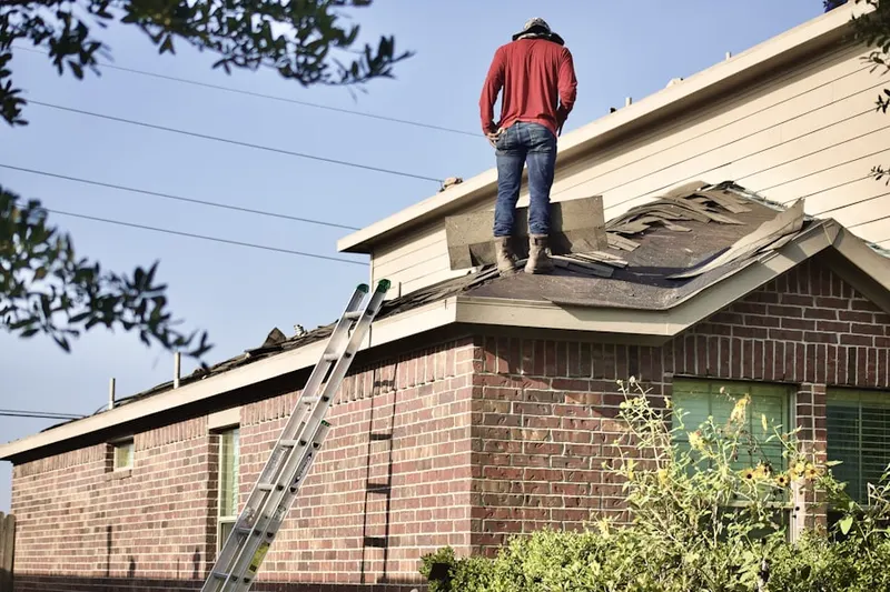 Professional roofer working on a residential roof in Bustleton